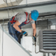 HVAC Technician Installing New Warehouse Air and Water Heaters