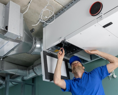 Maintenance worker inspecting HVAC unit